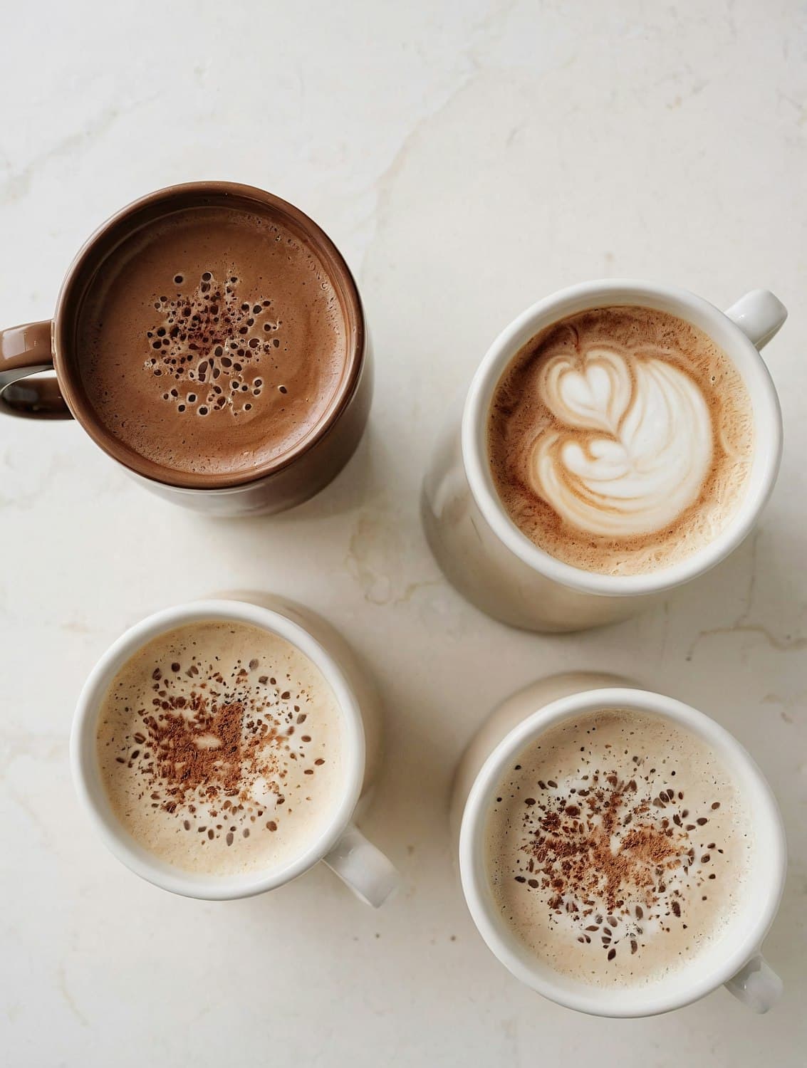 Hot chocolate and milky coffees seen from above